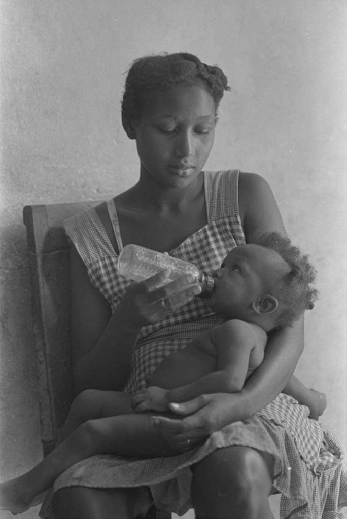 Woman feeding a baby