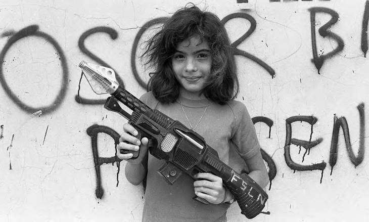young girl holding rifle smiling