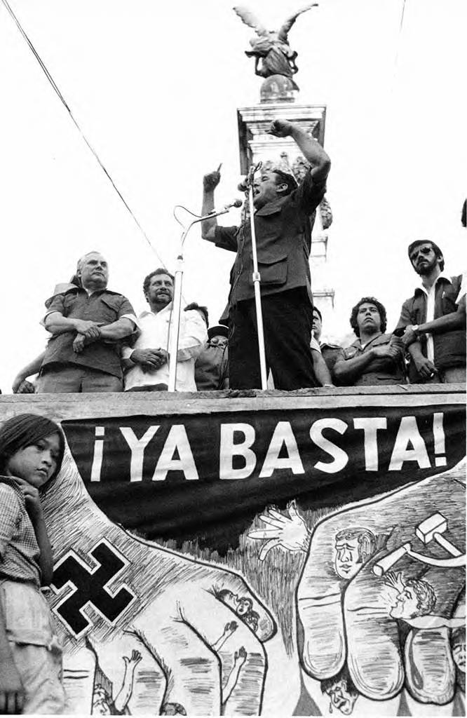 José Napoleón Duarte speaks above a poster