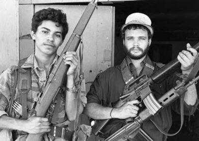 two men holding rifles and posing