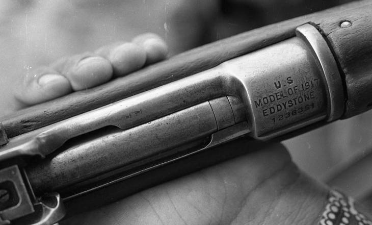 The close-up of an M1 Garand rifle
