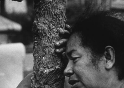 Woman mourning near a cross