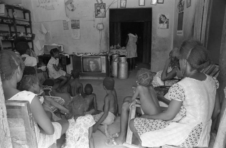 Elderly, adults, and children watching TV