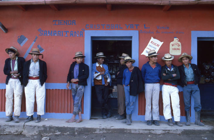 Mayan men leaning on a store wall, Chajul, 1982