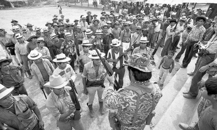 Mayan men stand in formation,