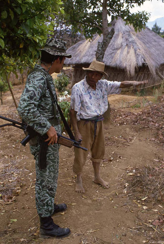 Soldier question Mayan man about guerilla movements
