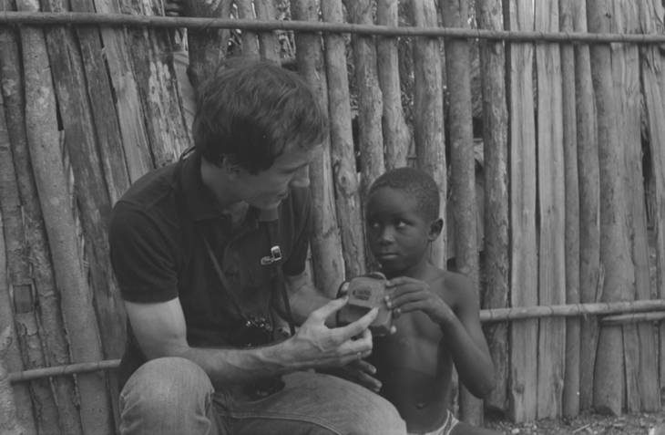 Richard Cross and a boy examining a toy camera