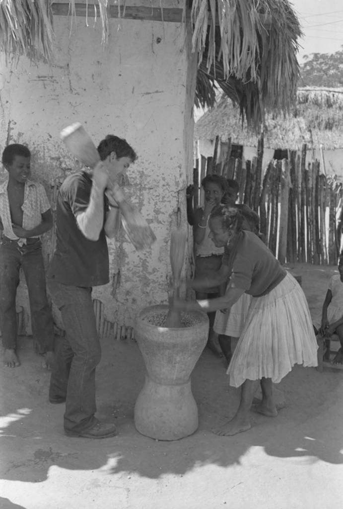 Richard Cross and woman grinding corn